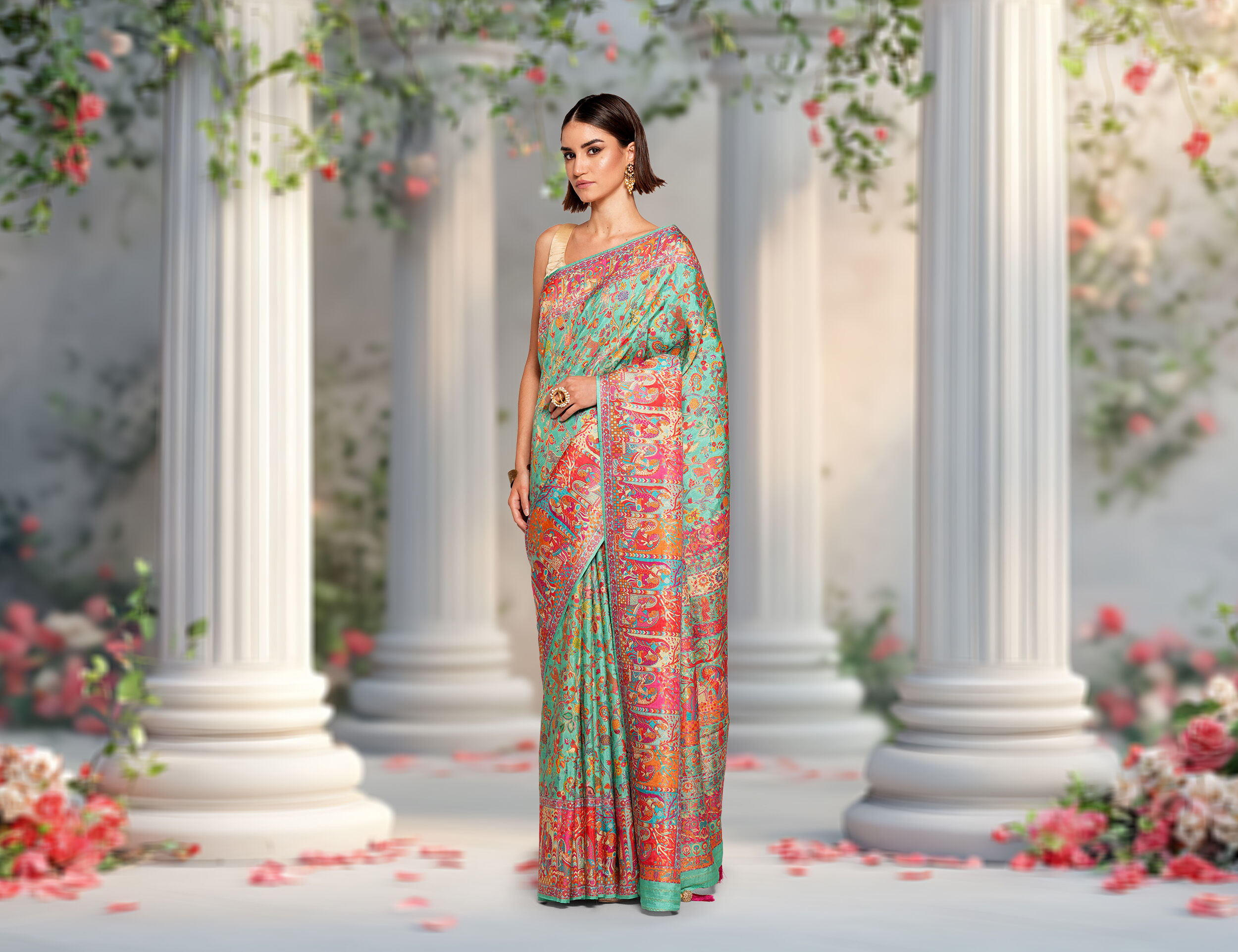 Woman in a floral saree stands in a garden setting, ideal for garden weddings. Perfect for bridal planning and wedding attire inspiration.